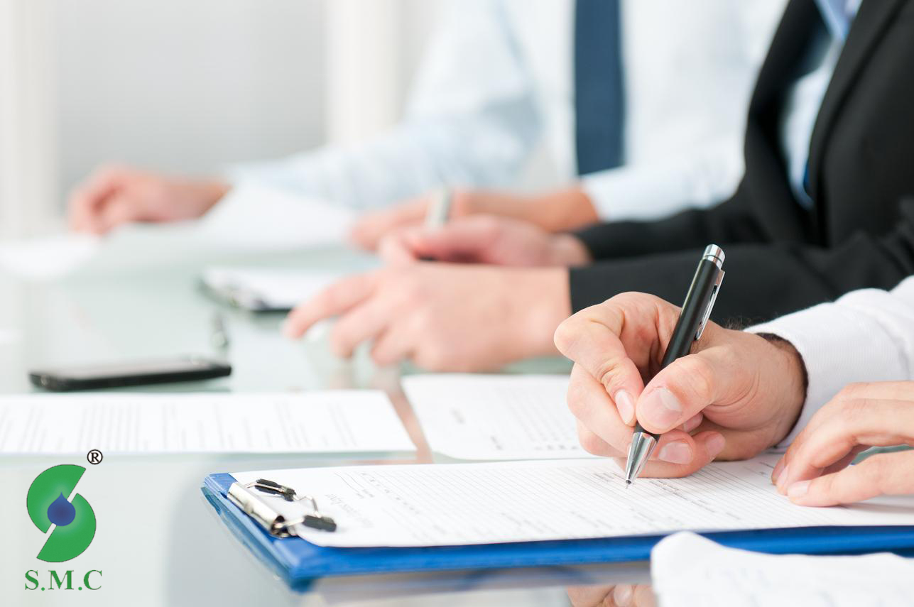 Close up shot of people compiling forms during a business conference